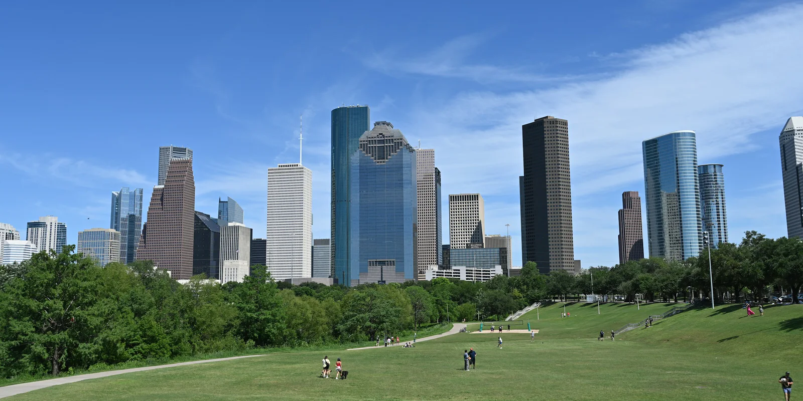 Downtown Houston skyline viewed across a green city park