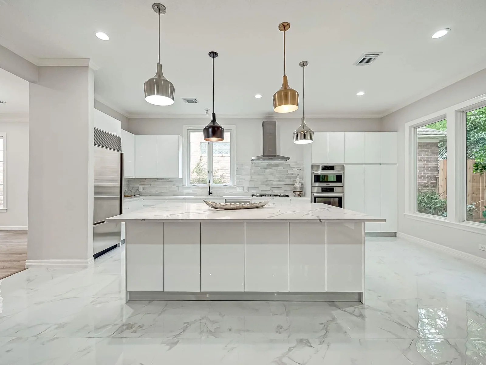 Bright European-style kitchen with white cabinets and a large island