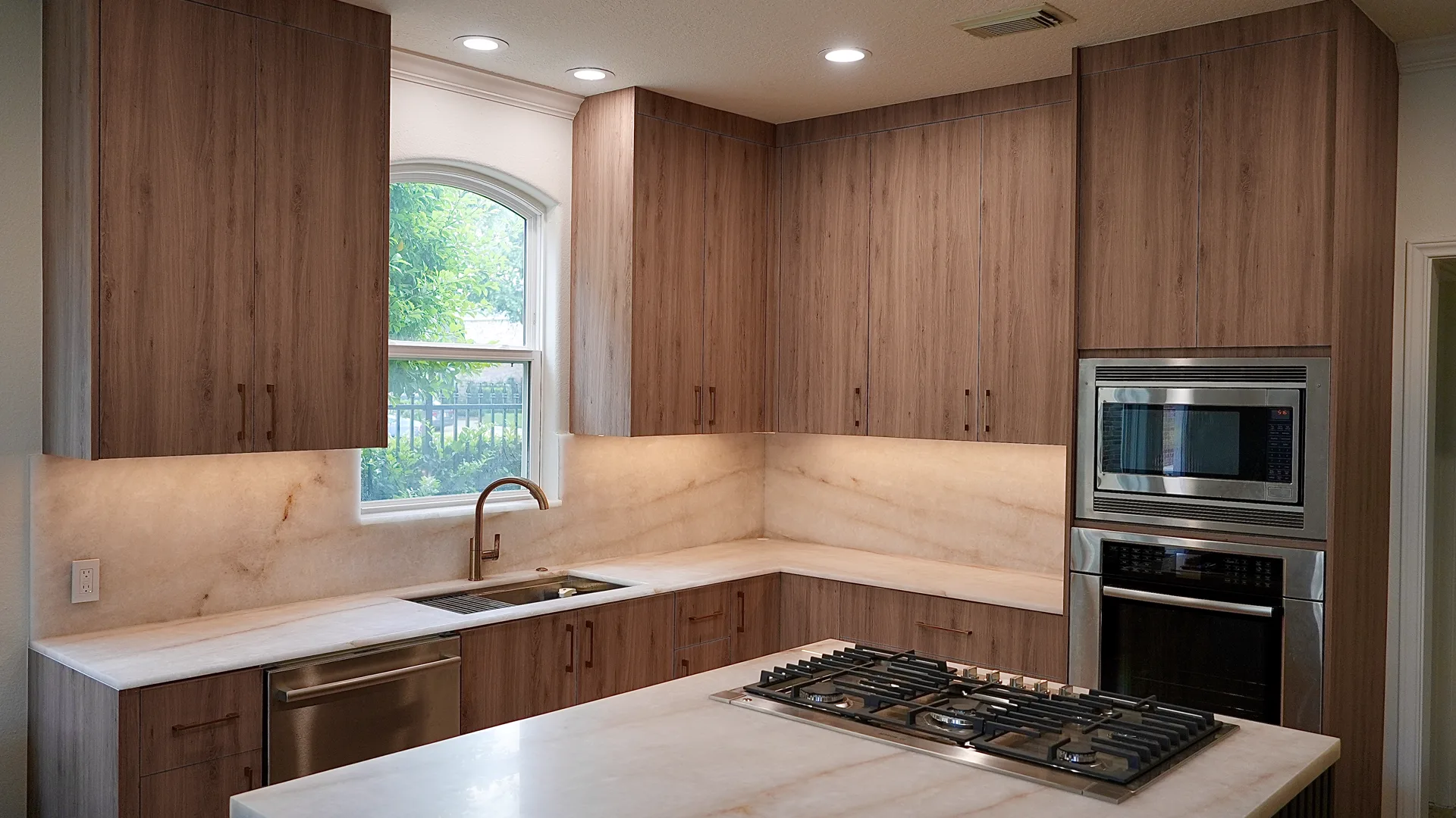 Custom-home kitchen with wood cabinets and stone counters